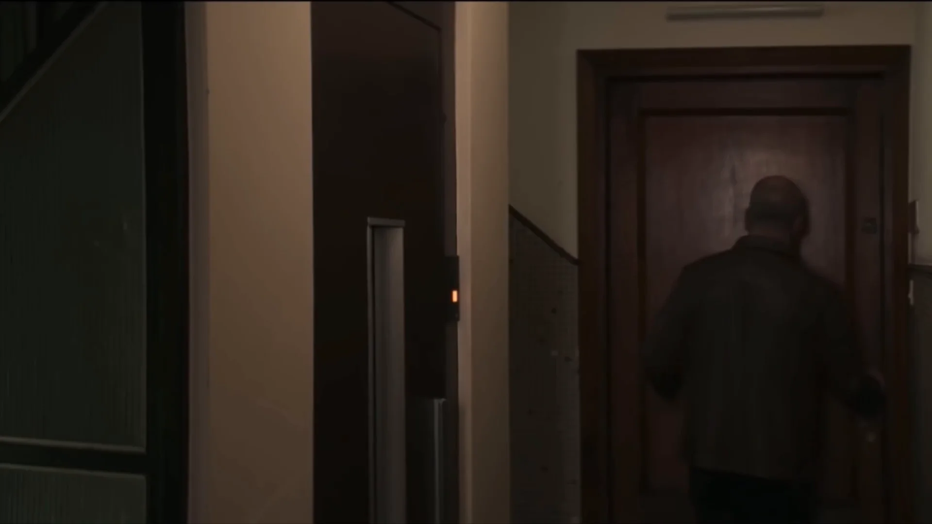 Still from Emperor Code: A man enters a door in a dark corridor