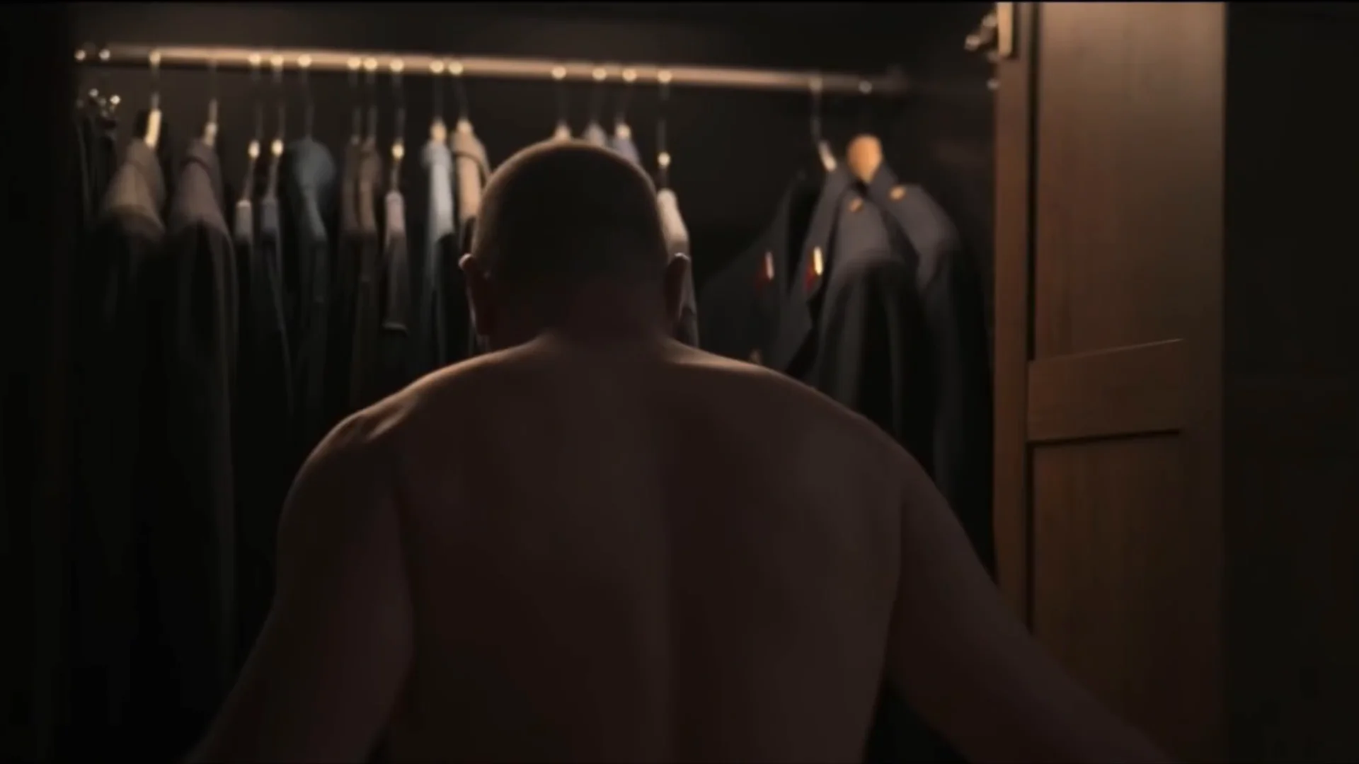 Frame from Emperor Code: a man with his back to a wardrobe